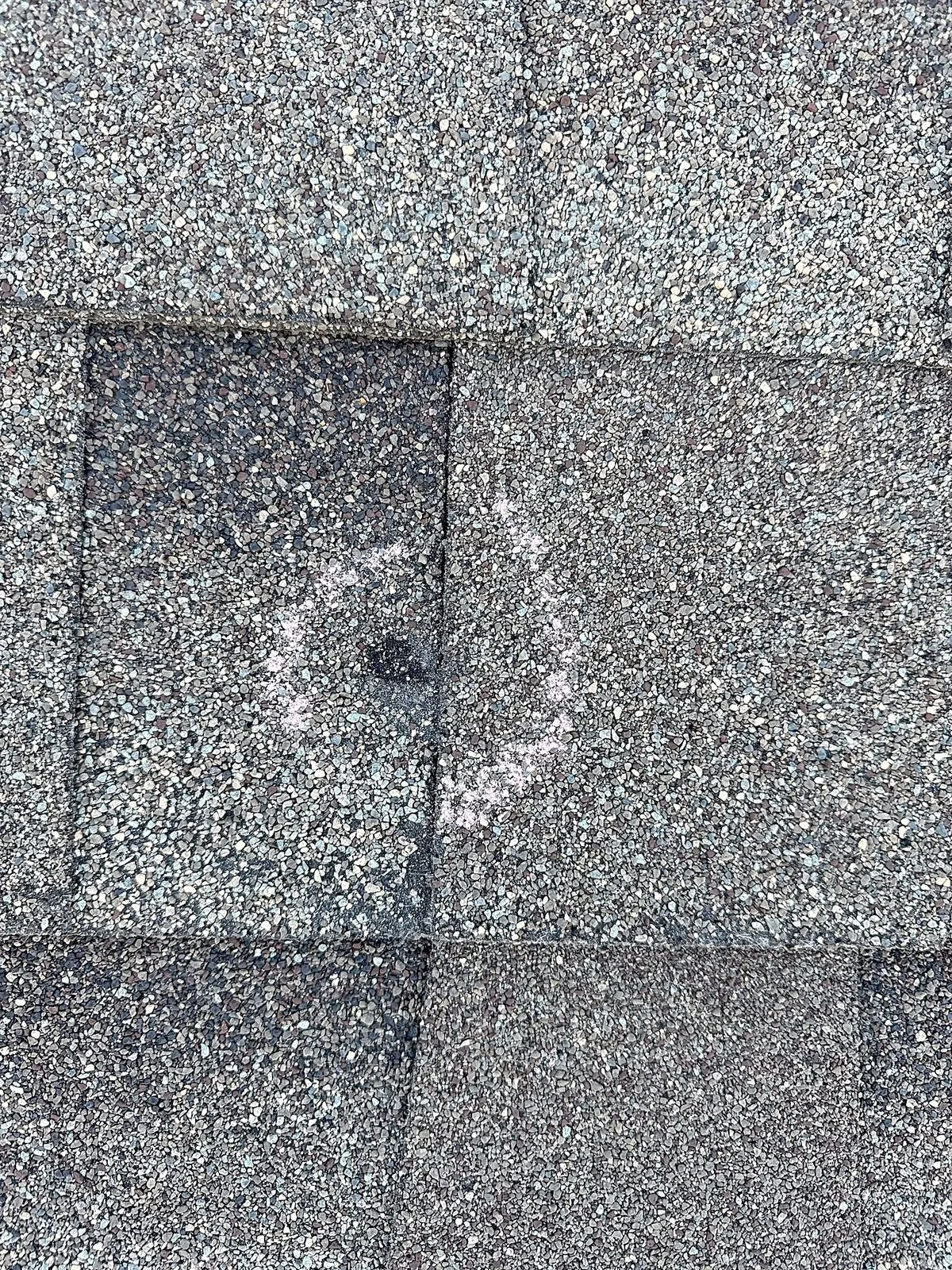 Chalked hail strike on a Plano roof slope