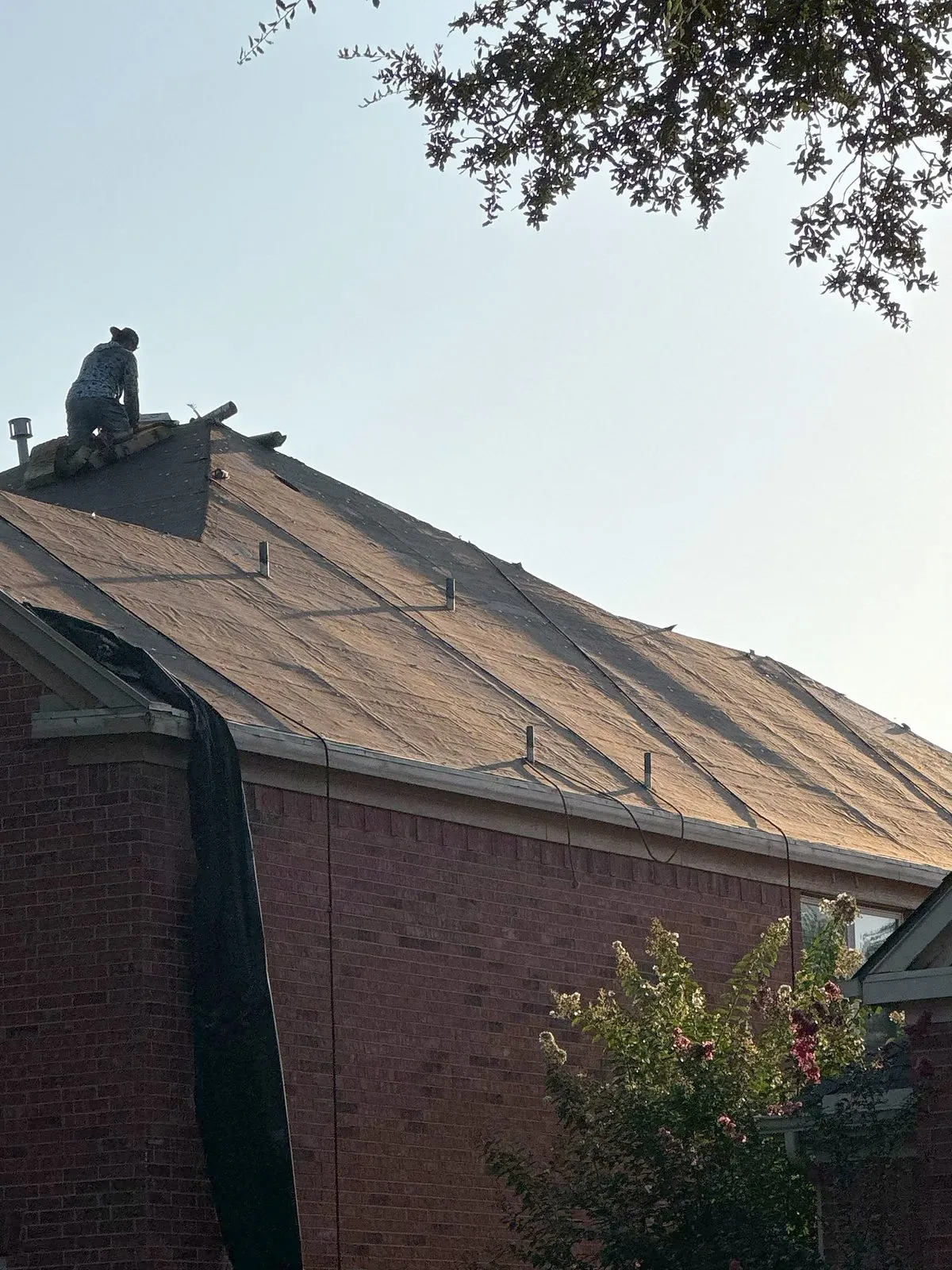 Crew removing the old roof covering