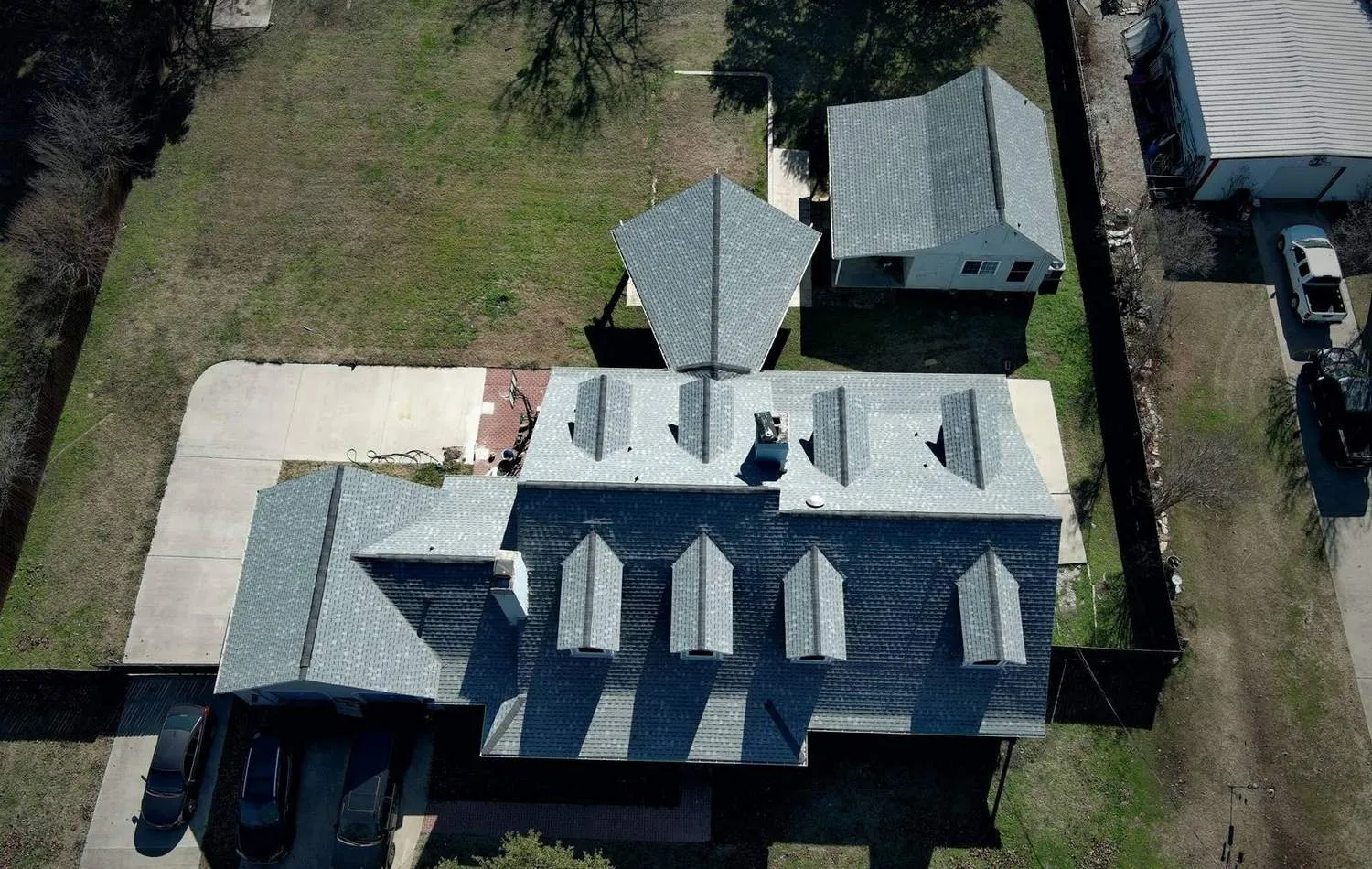 Aerial view of a completed roof replacement by Peoples Construction in North Dallas