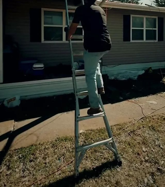 Peoples Construction team member working on a roof